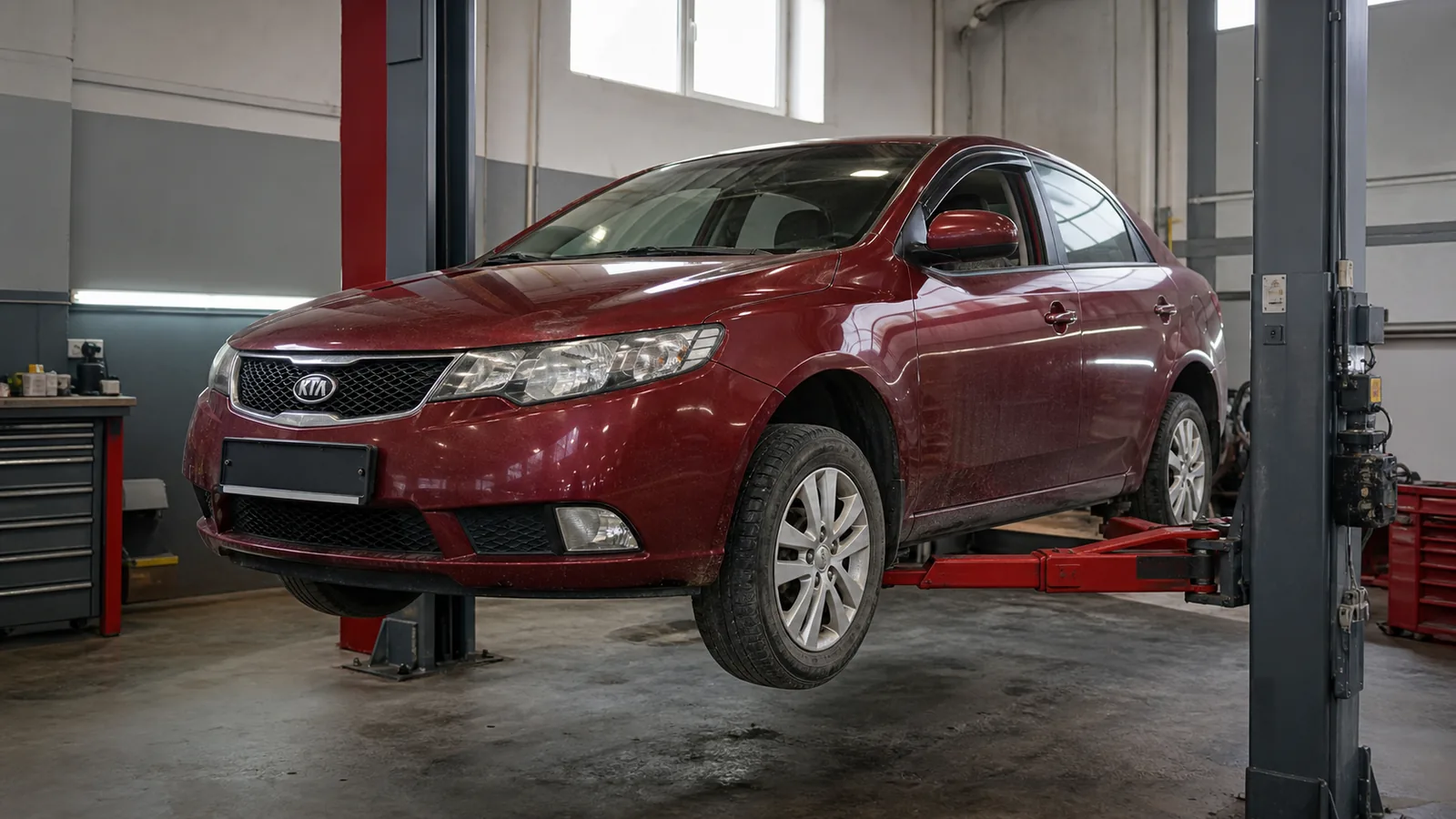 Kia Cerato на подъёмнике во время проверки подвески и тормозов — иллюстрация